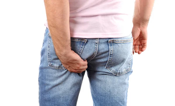 Mannen i jeans repor hand sin kliande botten — Stockfoto