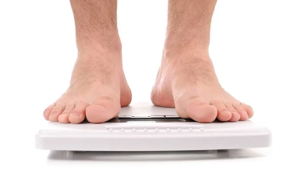 Man standing on weight scale — Stock Photo, Image