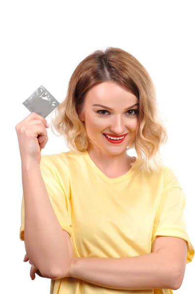 Beautiful girl is holding a condom — Stock Photo, Image