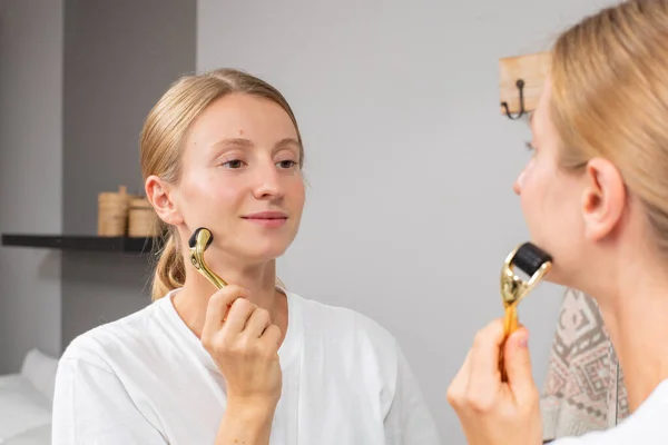 Dermaroller. Woman is making procedure on face with meso roller in home — Stock Image Dermaroller. Woman is making procedure on face with meso roller in home Stock Picture