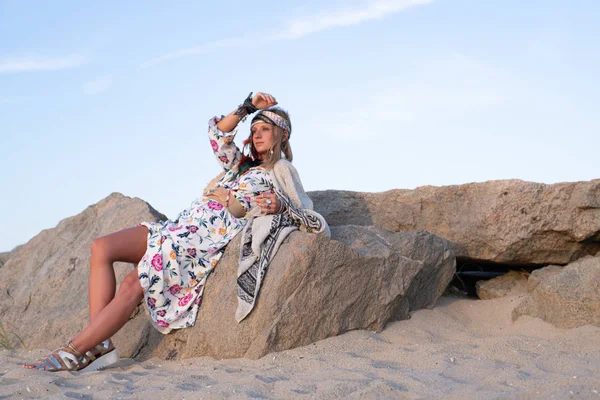 Beautiful woman wearing long dress and accessories boho style. Bohemian style girl on the beach — Stock Photo, Image