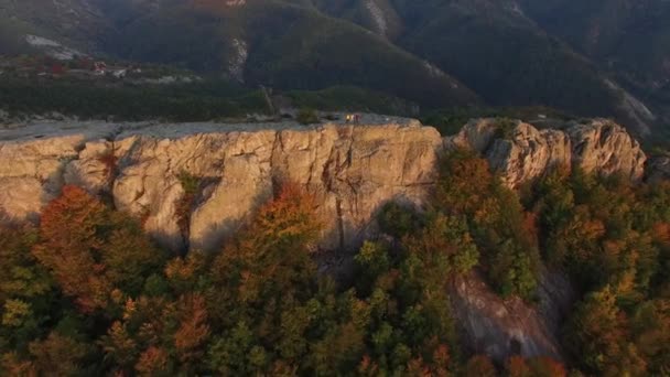 People waving from a huge mountain rock — Stockvideo