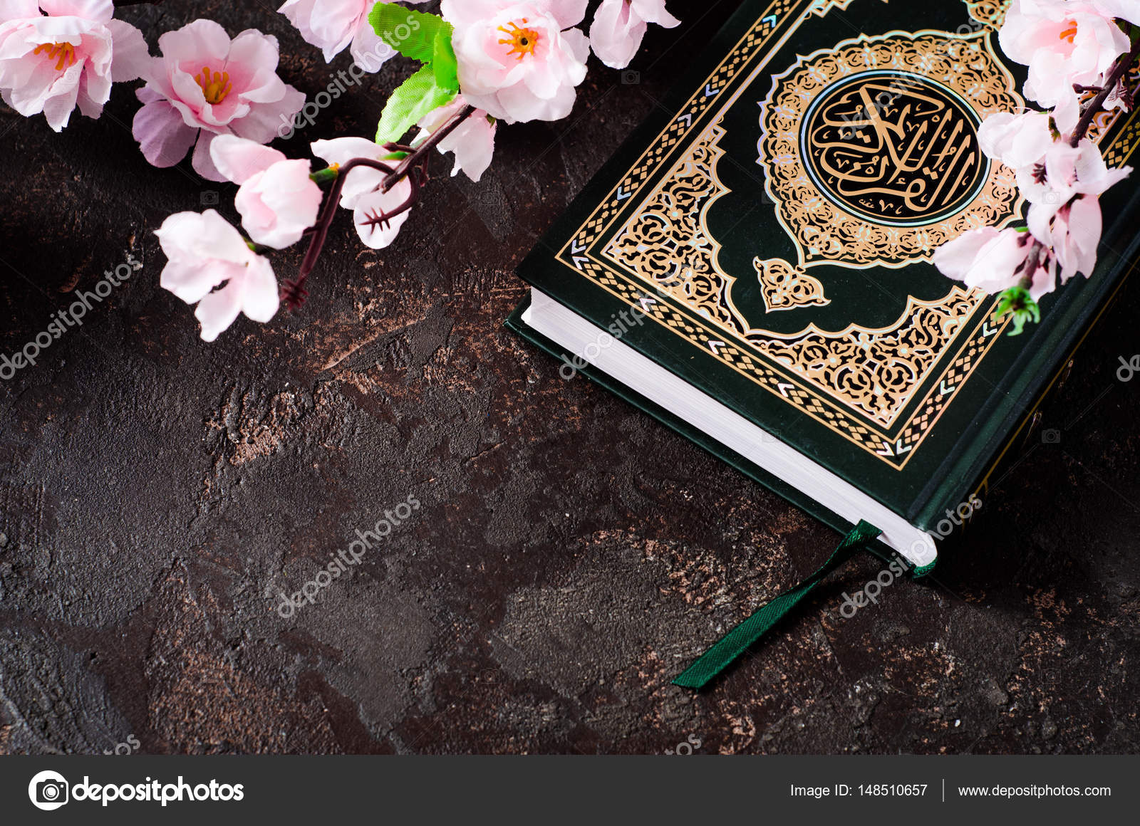 Islamic Book Koran and spring flowers brunch on dark background ...