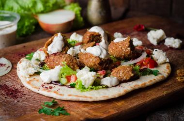 Ev yapımı pizza falafel ve krem peynir vintage ahşap tahta üzerinde. Arap mutfağı. Seçici odak. Tonlu görüntü