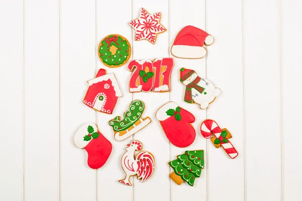 Biscoitos de gengibre coloridos de Natal em backgroun de madeira branca — Fotografia de Stock