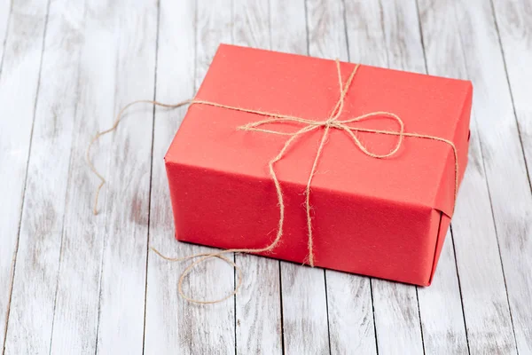 Red gift box on wooden background. — Stock Photo, Image