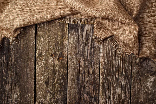 Holzbackgrond mit einem Stück Stoff. — Stockfoto
