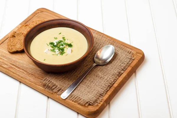 Broccoli cream soup on white wooden table. — Stock Image Broccoli cream soup on white wooden table. Stock Photo