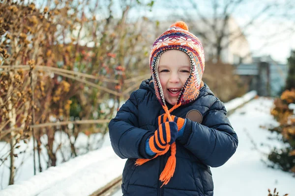 Séta a szabadtéri téli időben aranyos kisfiú. Gyerek játszik a hó. — Stock Fotó