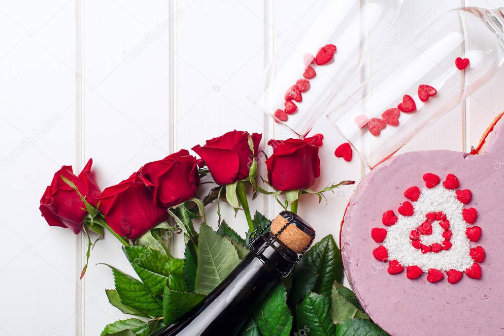 Valentines day card. Bouquet of red roses, cake and champagne.