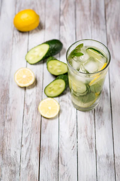 Water with lemon, mint and cucumber on wooden light background. Water Detox. — Stock Photo, Image