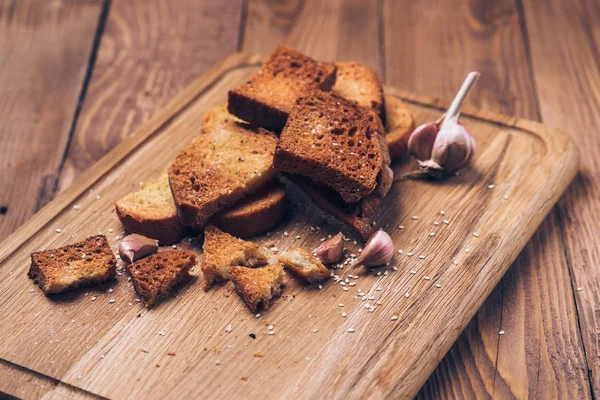 Bread crumbs, spices, garlic on wooden background.