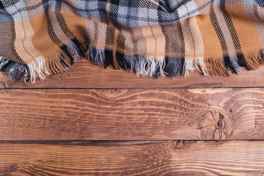 Rustik ahşap arka plan üzerinde kahverengi kareli ekose.