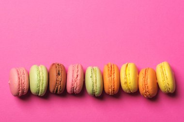 Parlak pembe renkli macarons kağıt arka plan, üstten görünüm, boşaltmak.