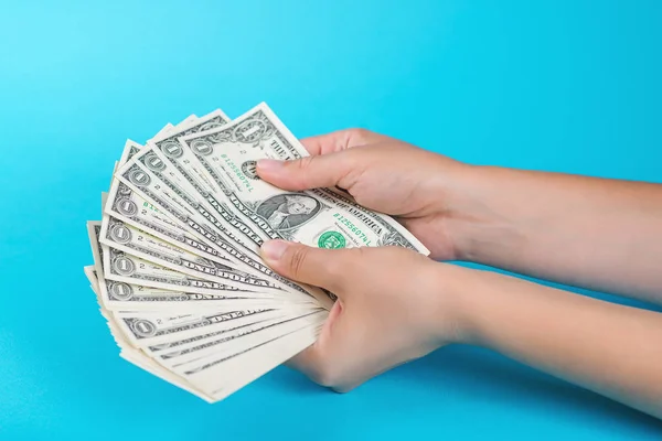 Female hands with money on a blue background. Economy concept. Allocation of money. — Stock Photo, Image