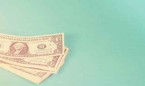 Concept savings, finances, economy . One dollars banknotes isolated on blue backround. Toned. — Stock Photo, Image