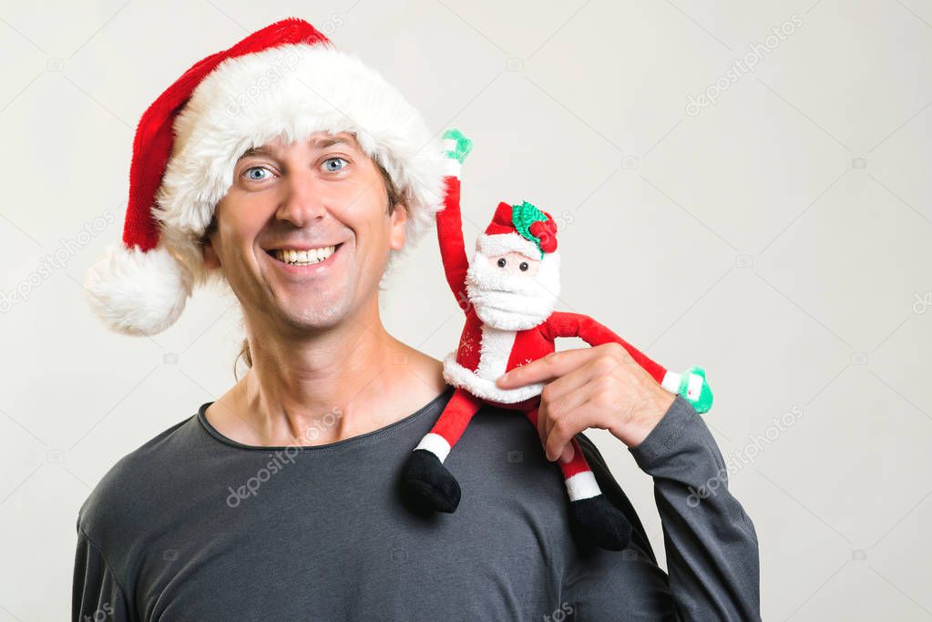 Happy 2020 Year. Happy man having fun with santa toy. 