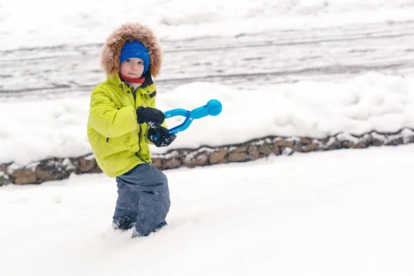 Aranyos gyerek játszik hó a téli parkban. Havas hideg téli időjárás. Családi téli vakáció. — Stock Fotó