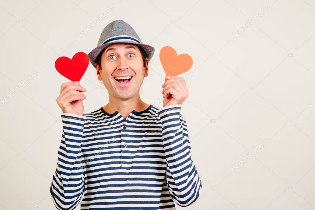 Happy man in love. Romantic guy holds valentine cards. Be my valentine. Happy Valentine Day