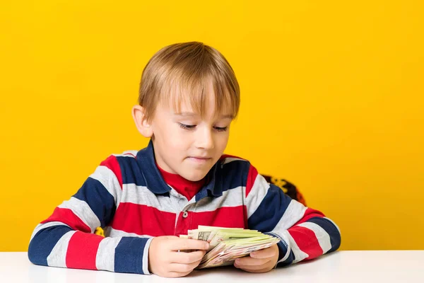 Smart boy counting money at table. Finance education. Cute boy saving money for future education. — Stock Photo, Image