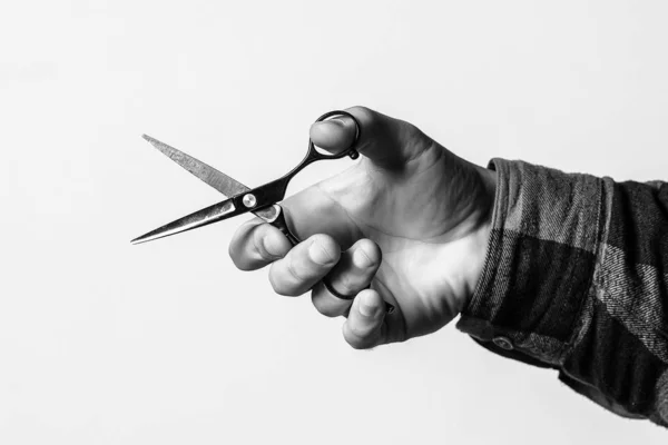 Barber scissors over background with copy space. Barber shop. Hairdresser hand holds scissors, cropped image. — Stock Photo, Image