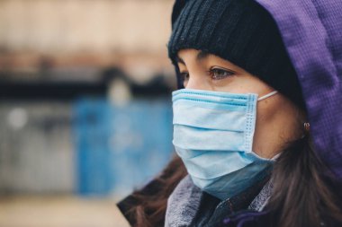 Woman wears protective mask outdoor. Mask against infectious diseases and flu. Health care concept. Stop the infection. Coronavirus quarantine.