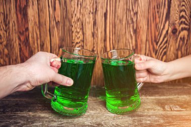 Friends toast with each other. Saint Patrick's day party.