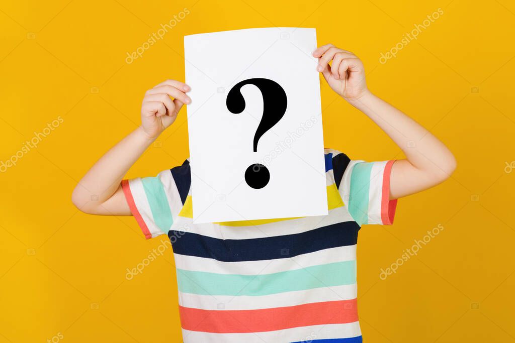 Child covered face with question mark. Schoolboy shows question mark. Cute little boy asking question. Kid ideas and brainstorm. Education and development.