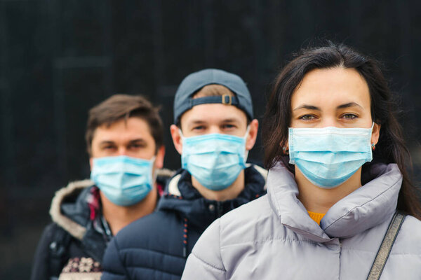 People wearing face masks outdoors. Coronavirus quarantine. Air pollution. Global pandemic. Coronavirus epidemic. 2019-nCoV.