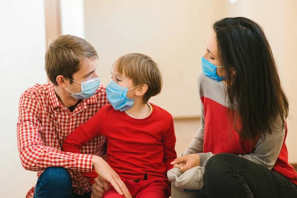 Family wearing safety medical masks. Prevention coronavirus. Stay at home. Home quarantine. Coronavirus epidemic. Parents and kid wearing a surgical masks. Coronavirus outbreak. New real life.