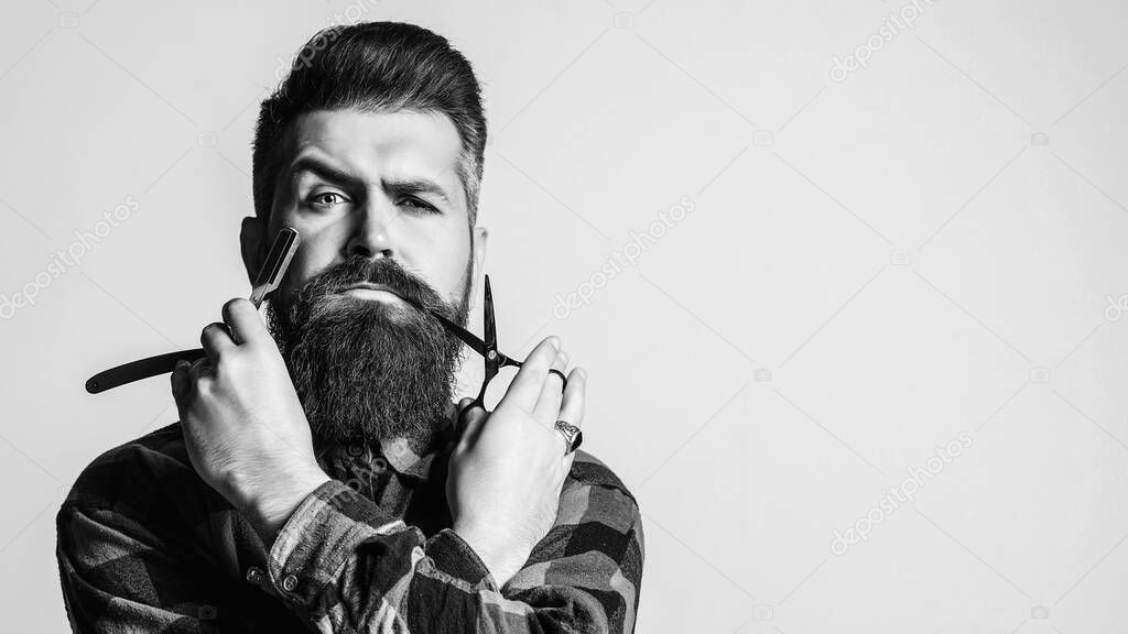 Barber with straight razor and scissors. Brutal man holding proffecional tools. Barber shop. Mens haircut. Vintage barbershop, shaving. Barber scissors. Vintage straight razor. Barbershop advertising.