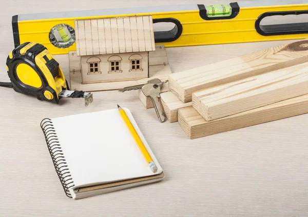 Construction concept, model house,work tools and notebook.Copy space for text. — Stock Photo, Image