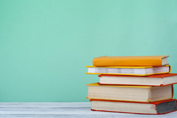 Stack of books on the wooden table. Education background.Back to school.Copy space for text.