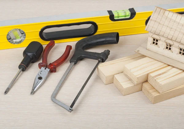 Construction concept, model house and tools on wooden table.Copy space for text. — Stock Photo, Image