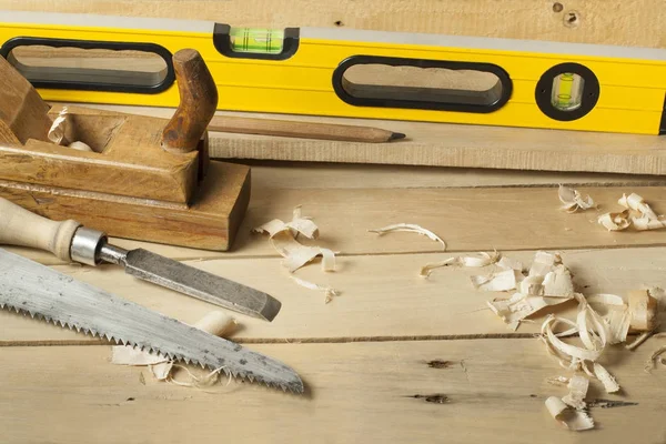 Carpentry concept.Joiner carpenter workplace. Construction tools on wooden table with sawdust. — Stock Photo, Image