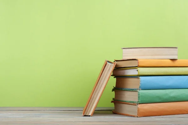Στοίβα από πολύχρωμα βιβλία πάνω στο ξύλινο τραπέζι. Υπόβαθρο εκπαίδευσης. Πίσω στο σχολείο. Χώρο αντίγραφο για το κείμενο. — Φωτογραφία Αρχείου