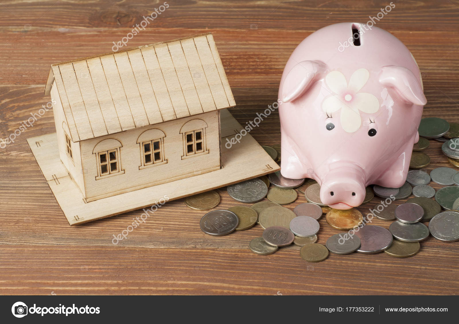 Epargne, concept de budget. Maison modèle, tirelire et pièces de monnaie  sur table de bureau en bois . image libre de droit par Motizova © #177353222