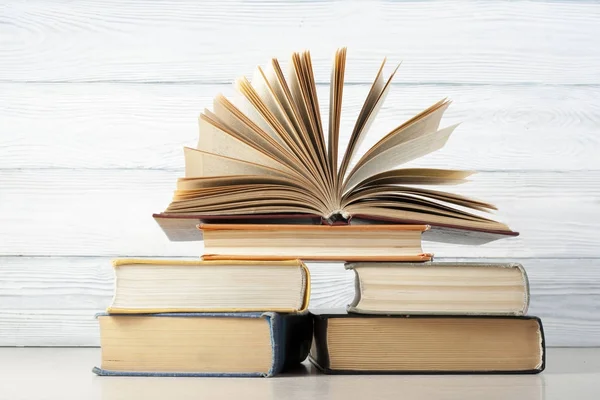 Open book, hardback books on wooden table. Education background. Back to school. Copy space for text. — Stock Photo, Image