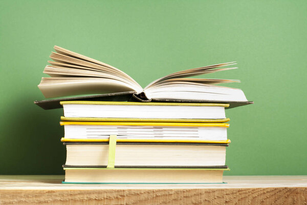 Open book, hardback books on wooden table. Education background. Back to school. Copy space for text.