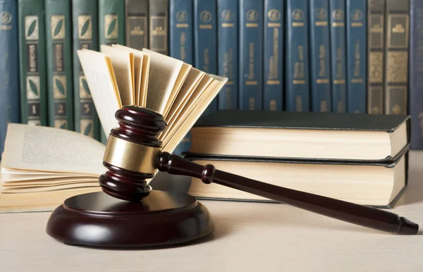 Concepto de ley. Libros con jueces de madera martillo en la mesa en una sala de tribunal u oficina de aplicación de la ley . —  Fotos de Stock