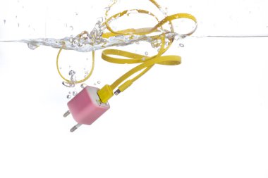 Battery charger falling into water clipart