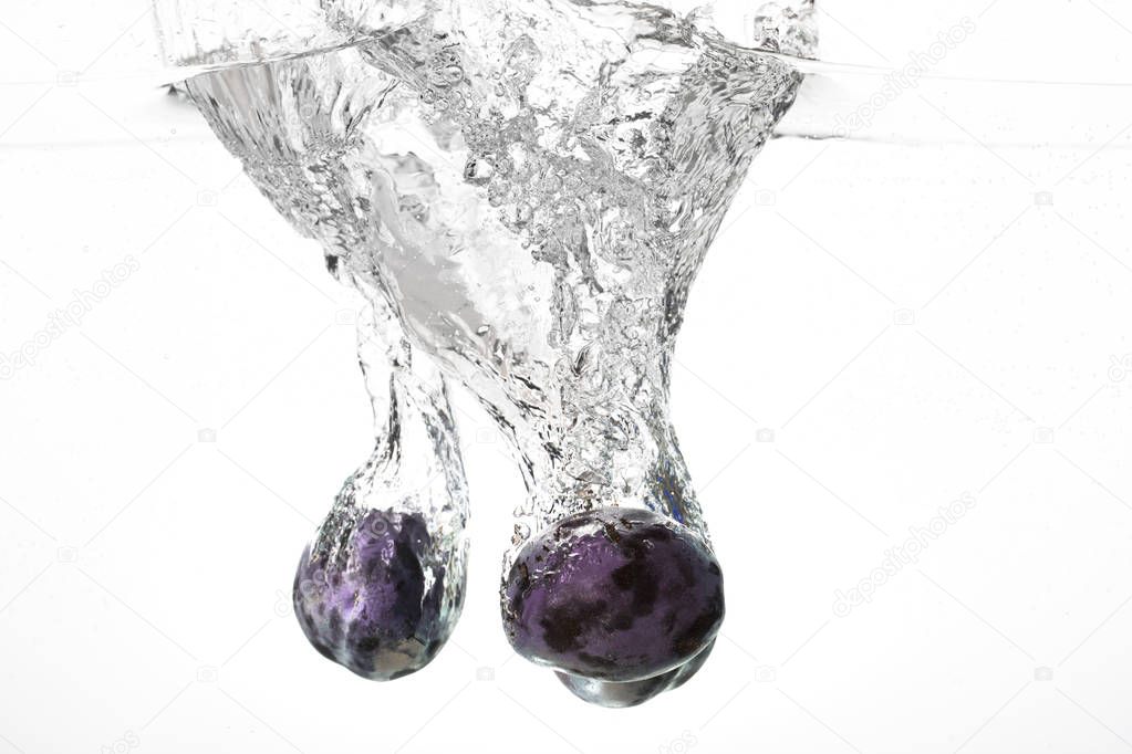 Plum falling in water