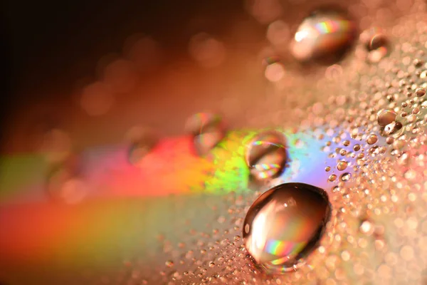 Water Drops on CD and DVD. Colorful background. — Stock Photo, Image