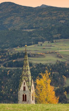The Church of Villandro in Autumn season. Bolzano, Italy. clipart