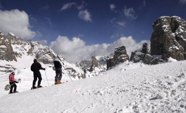 Skier near Cinque Torri group in the Dolomites. Cortina d'Ampezzo, Veneto. Italy clipart
