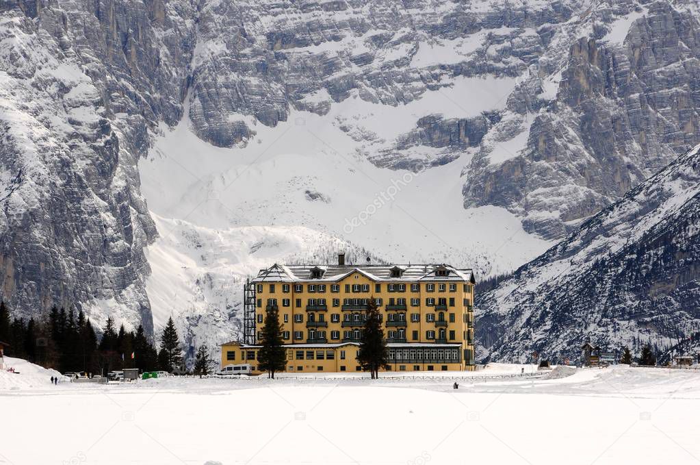 Winter scene of Misurina lake with Istituto Pio XII on the south side of Lake Misurina, (was once the luxurious Grand Hotel Savoia) and the Sorapiss group in the italian Dolomites. Veneto, Italy.