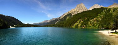 Rasun, July 2019: Scenic view of Antholzer See (Italian: Lago di Anterselva) a beautiful turquoise colored lake in South Tyrol, Italy. clipart