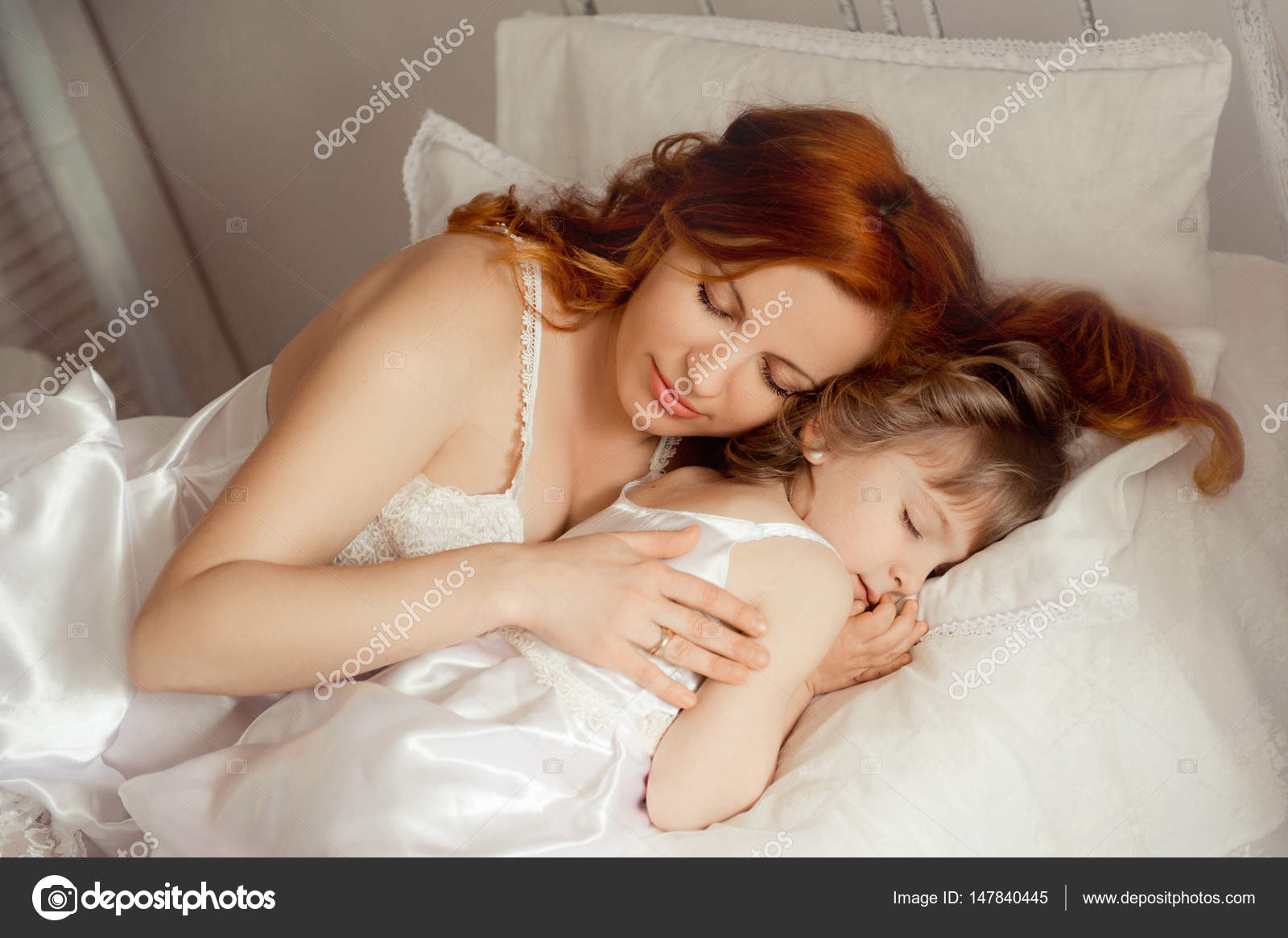 In bed next to mom