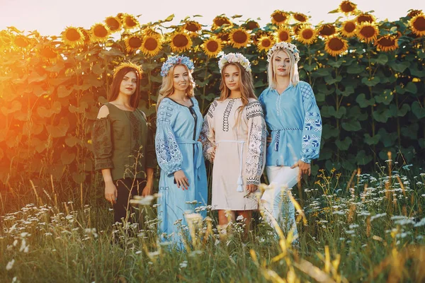 Girls and sunflowers — Stock Photo, Image