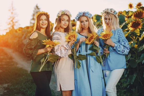 Girls and sunflowers — Stock Photo, Image